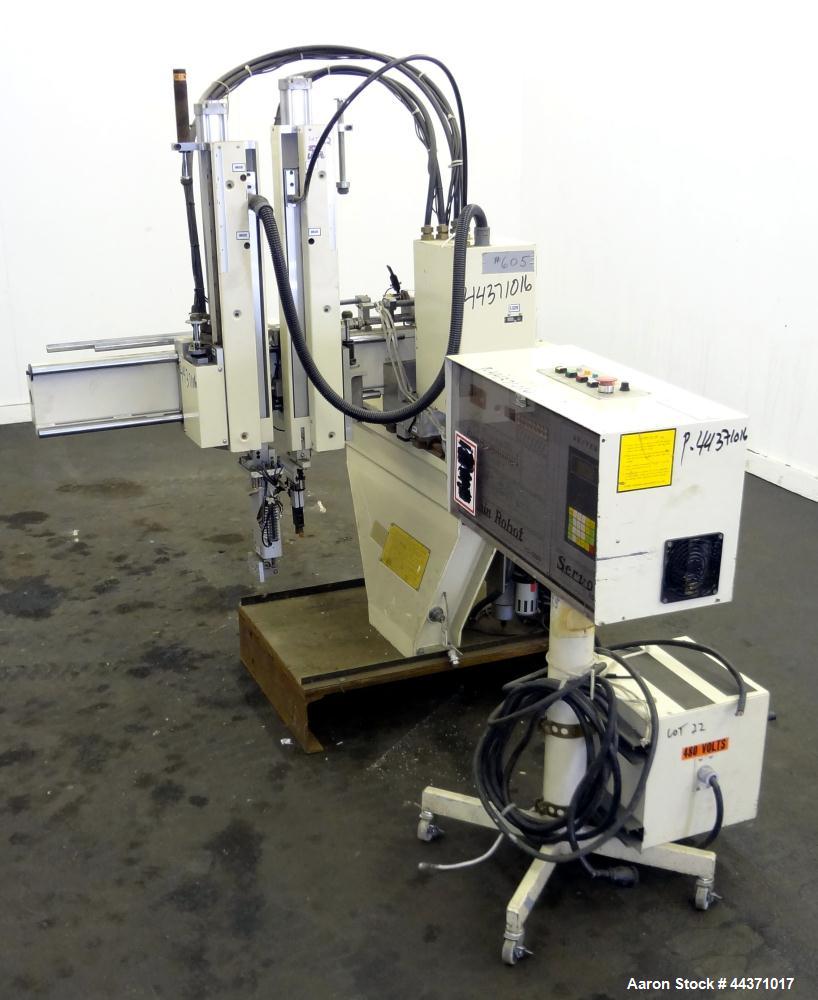 Used Yushin America Airliner AE-200D Robot. With a servo traverse and two pneumatic axes. Includes a model YC-3000 portable controller. Built 1993.