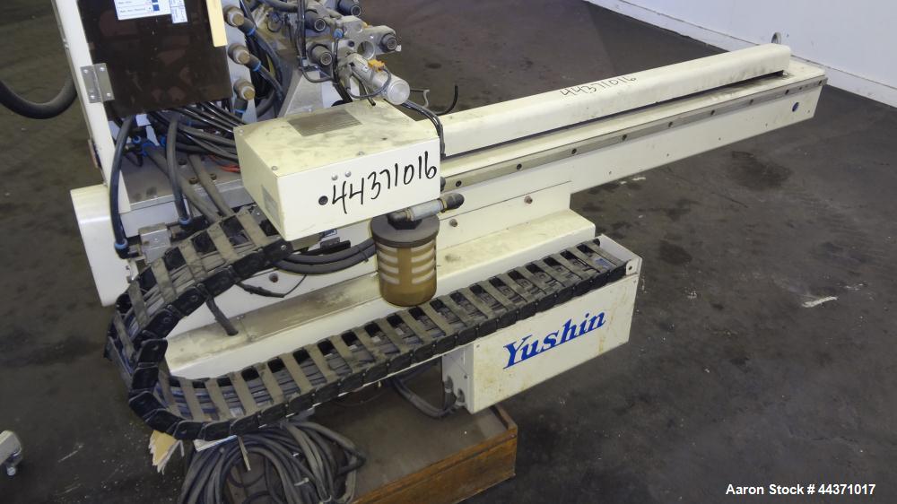 Used Yushin America Airliner AE-200D Robot. With a servo traverse and two pneumatic axes. Includes a model YC-3000 portable controller. Built 1993.