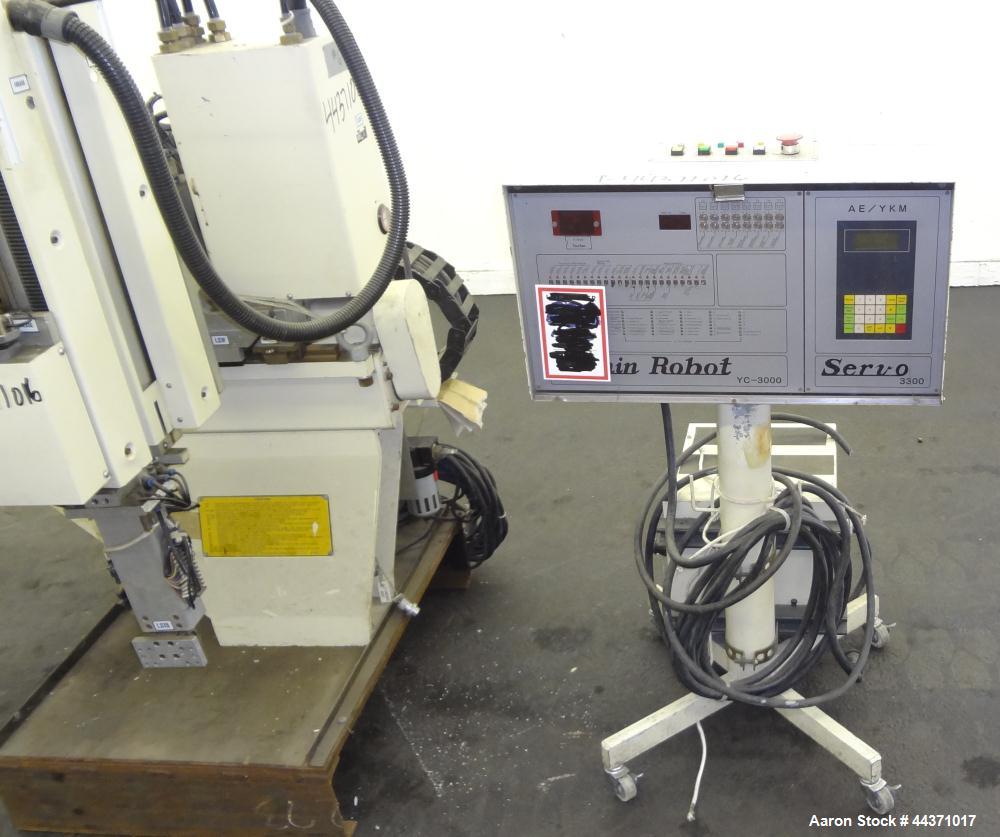 Used Yushin America Airliner AE-200D Robot. With a servo traverse and two pneumatic axes. Includes a model YC-3000 portable controller. Built 1993.