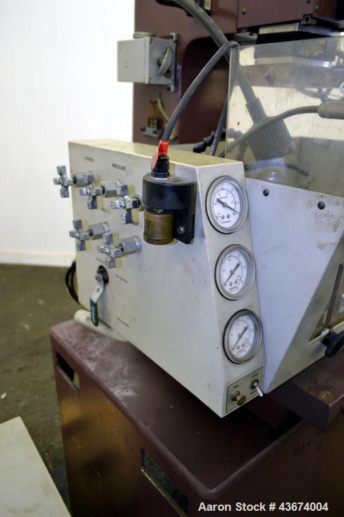Used Hansvedt Ram Type EDM, Model Benchman. Work table size 9.4" x 14.2", table travel 5.5" x 8.5", work tank size 16" x 24" x 11" high, platen to table 18" maximum, 10" minimum, ram travel 8", plate...