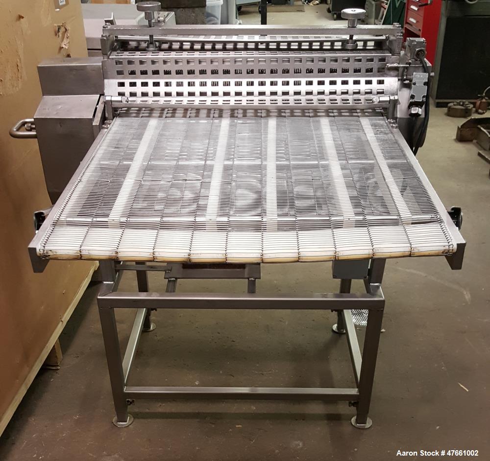 Used Formax Cuber-Perforator, Model MC.  27. 26" Wide usable belt, 1.5 hp drive, 460V/3PH/60HZ, 1.5 Amps,  scores portions up to 1.25 " thick, top and bottom scoring, with infeed and exit conveyors. ...