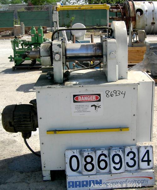 USED: Horizontal Two Roll Mill. (2) 6" diameter x 13" wide chrome plated cored rolls. (2) Knee safeties, (1) knife scraper. Manual roll adjustment. Driven by a 1 HP, 3/60/220/440 Volt, 900 RPM US var...