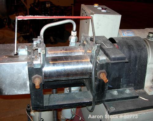 USED: C W Brabender horizontal two roll prep mill, model PM2000. (2) 4" diameter x 8" wide chrome plated cored rolls. Operating volume approx 250 ml. Adjustable end guides, (1) knee safety, (1) knife...