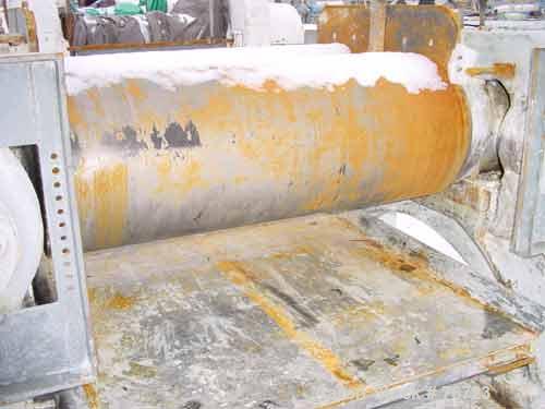 USED: Farrell horizontal two roll mill. 18" diameter x 48" long ironcored rolls. Adjustable end guides, discharge pan. Manual rolladjustments. Driven by a 75 hp, 3/60/550 volt, 690 rpm motor thru aFa...