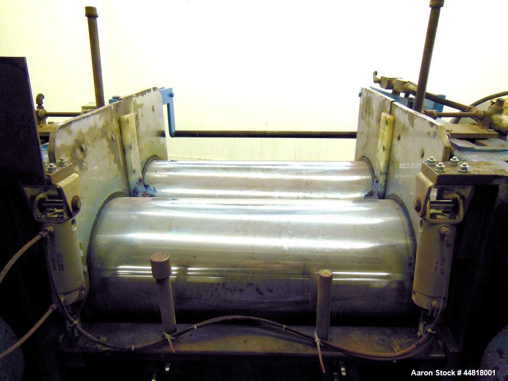 Used Reliable Rubber & Plastic Machinery Horizontal Two Roll Mill.  (2) 12" Diameter x 30" wide chromed plated cored rolls.  Knife scraper, bottom drip pan edge guides.  Manual roll adjustment.  Driv...