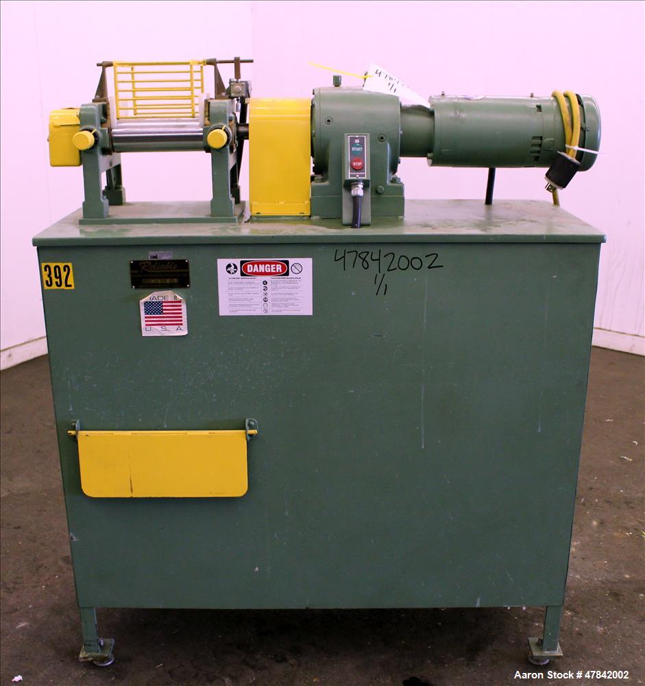 Used Reliable Rubber & Plastic Machinery Horizontal Two Roll Mill. (2) 3" Diameter x 8" wide chromed plated cored rolls. Manual roll adjustment, plastic edge guides, top safety cage, side knee safeti...