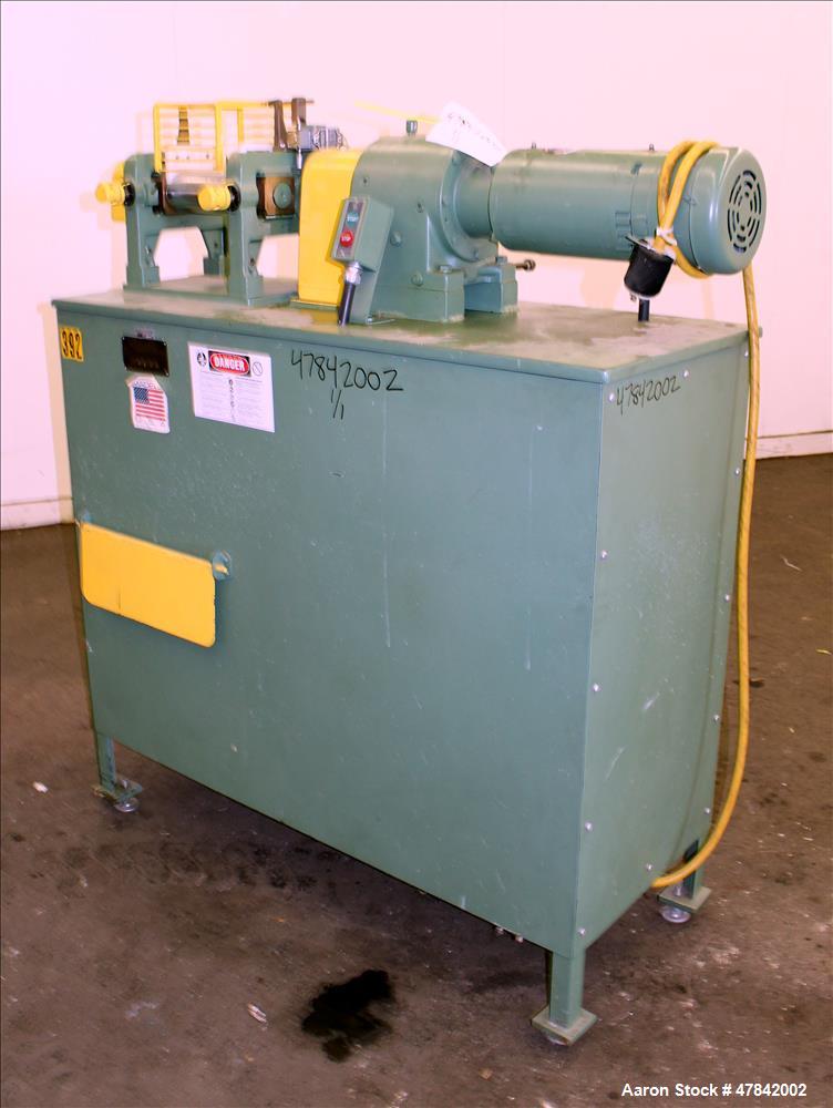 Used Reliable Rubber & Plastic Machinery Horizontal Two Roll Mill. (2) 3" Diameter x 8" wide chromed plated cored rolls. Manual roll adjustment, plastic edge guides, top safety cage, side knee safeti...