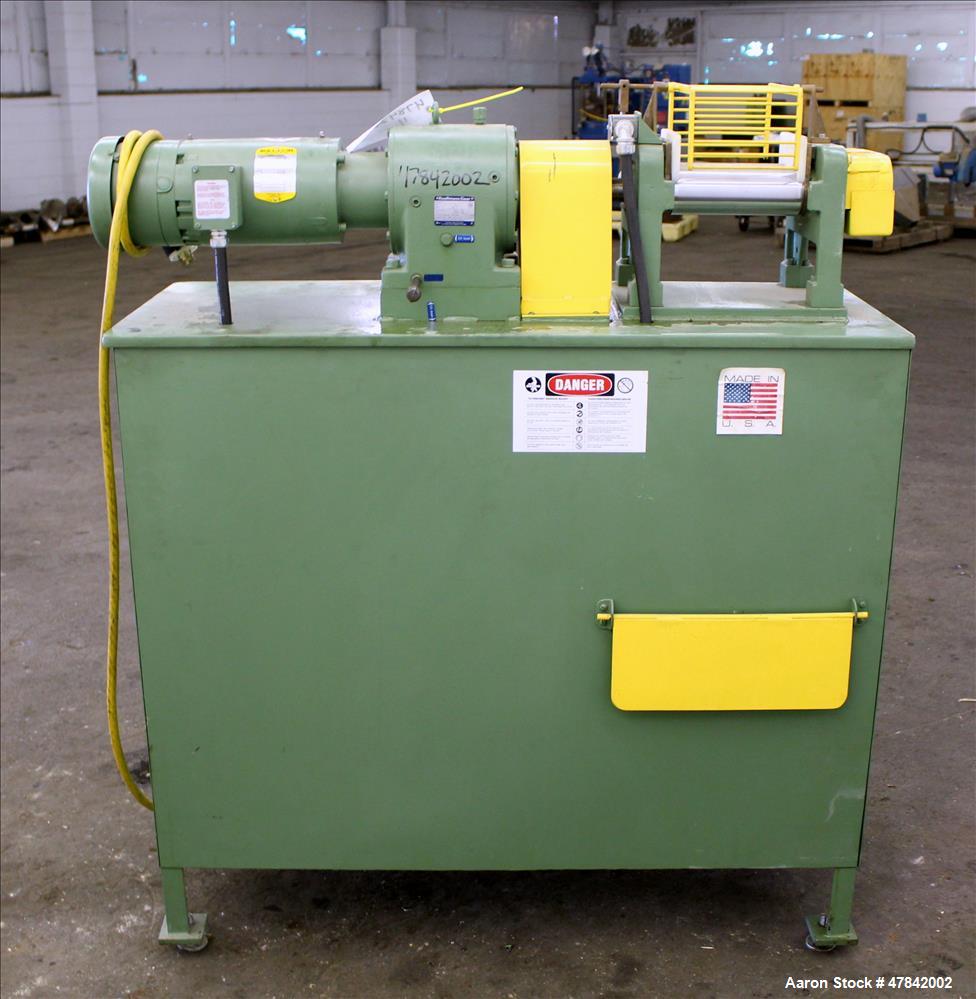 Used Reliable Rubber & Plastic Machinery Horizontal Two Roll Mill. (2) 3" Diameter x 8" wide chromed plated cored rolls. Manual roll adjustment, plastic edge guides, top safety cage, side knee safeti...