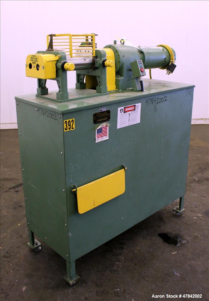Used Reliable Rubber & Plastic Machinery Horizontal Two Roll Mill. (2) 3" Diameter x 8" wide chromed plated cored rolls. Manual roll adjustment, plastic edge guides, top safety cage, side knee safeti...