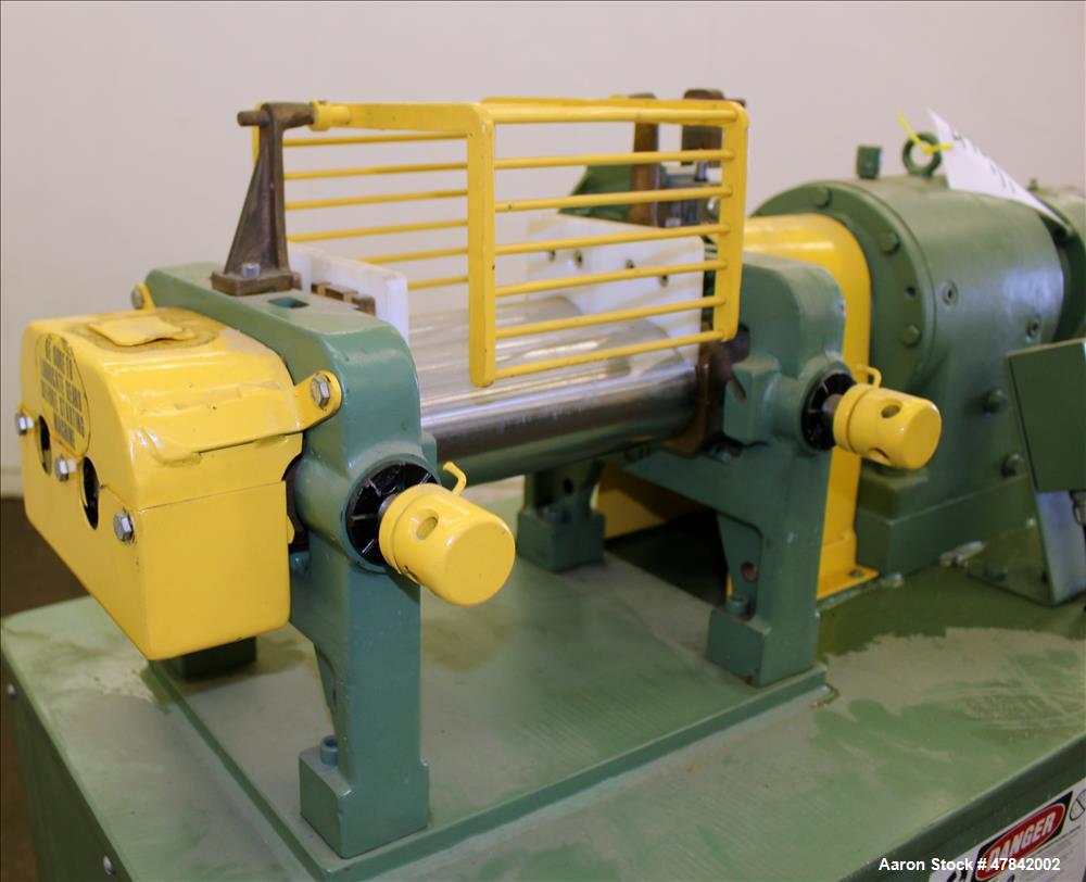 Used Reliable Rubber & Plastic Machinery Horizontal Two Roll Mill. (2) 3" Diameter x 8" wide chromed plated cored rolls. Manual roll adjustment, plastic edge guides, top safety cage, side knee safeti...