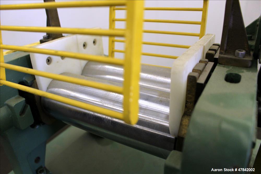 Used Reliable Rubber & Plastic Machinery Horizontal Two Roll Mill. (2) 3" Diameter x 8" wide chromed plated cored rolls. Manual roll adjustment, plastic edge guides, top safety cage, side knee safeti...