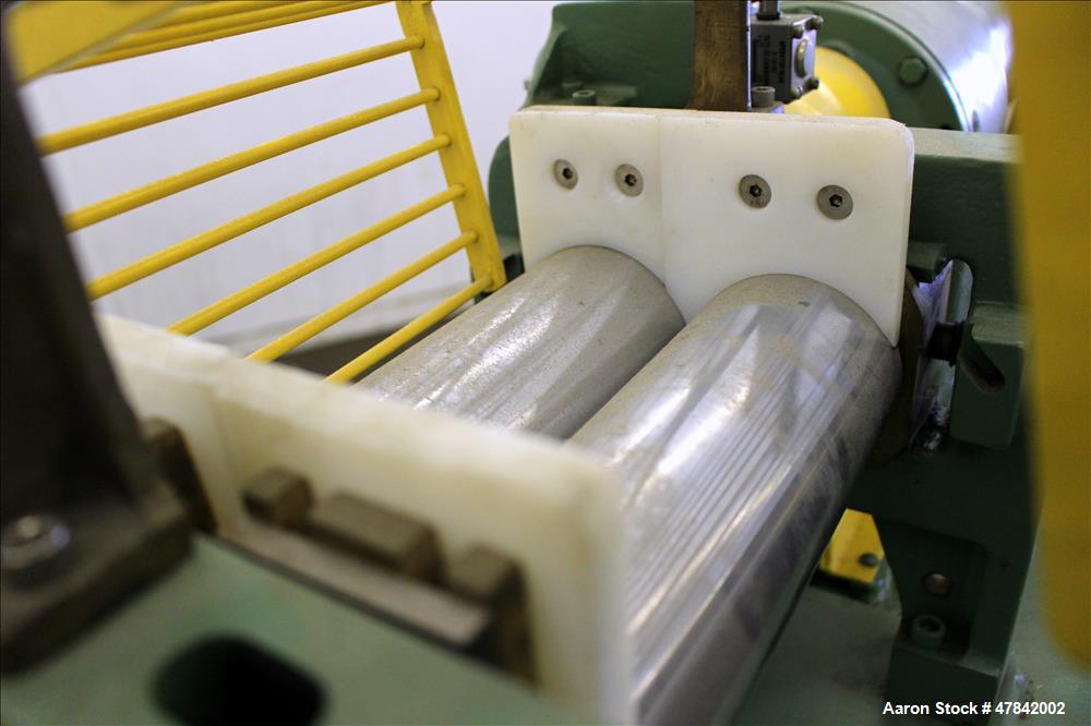 Used Reliable Rubber & Plastic Machinery Horizontal Two Roll Mill. (2) 3" Diameter x 8" wide chromed plated cored rolls. Manual roll adjustment, plastic edge guides, top safety cage, side knee safeti...