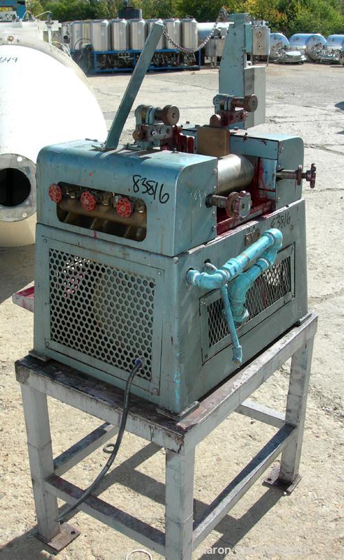 USED: Keith Machinery horizontal three roll mill, model 4 x 8. (3) 4" diameter x 8" wide cored rolls. Adjustable end guides, knife scraper with discharge pan, bottom drip pan. Driven by an approx 1 h...