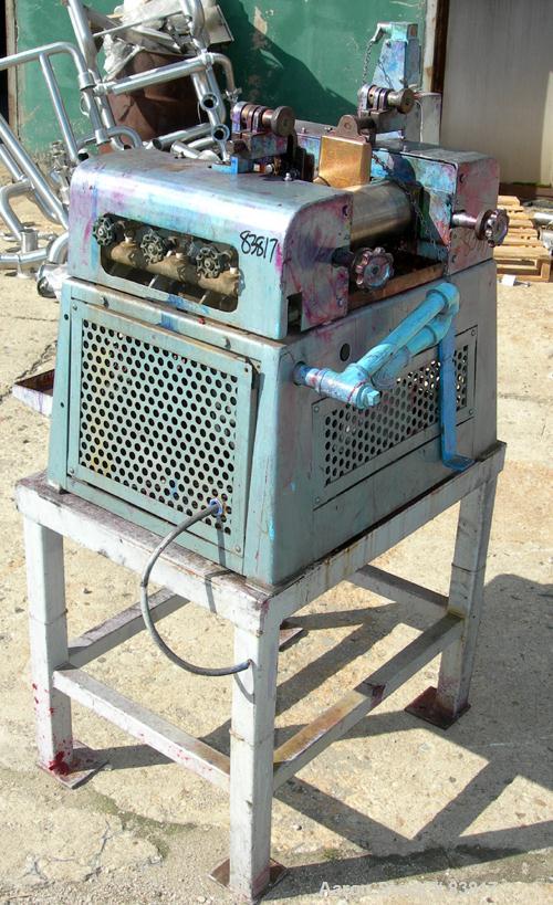 Used Keith Machinery Horizontal Three Roll Mill, model 4 x 8. (3) 4" diameter x 8" wide cored rolls. Adjustable end guides, knife scraper with discharge pan, bottom drip pan. Driven by an approximate...