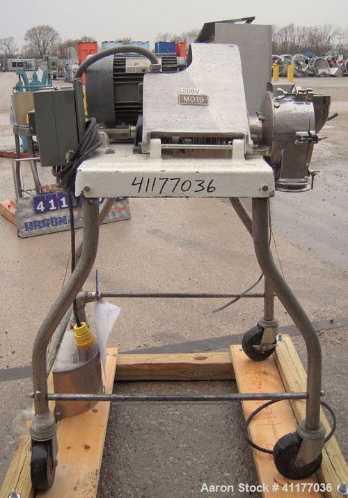 Used Fitzpatrick Homoloid Mill, Model JT, 304 stainless steel. 8'' diameter x 2'' deep chamber, (12) 410 stainless steel swinging double impact blades, bottom screen. Top feed, no pan. Driven by a 5 ...