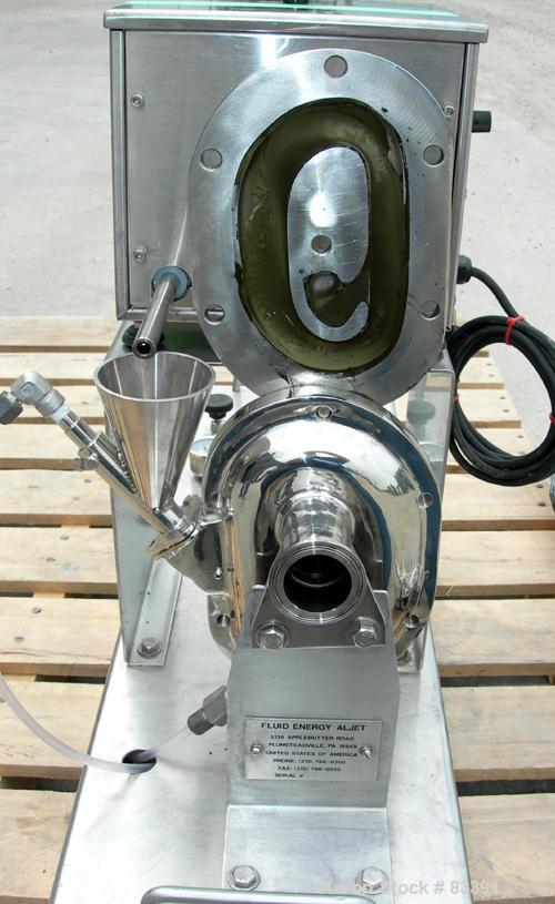 USED: Fluid Energy Aljet mill, 316 stainless steel. Top feed with hopper. 2" tri-clamp outlet. Includes an Accurate feeder with hopper. Mounted on a stainless steel base.