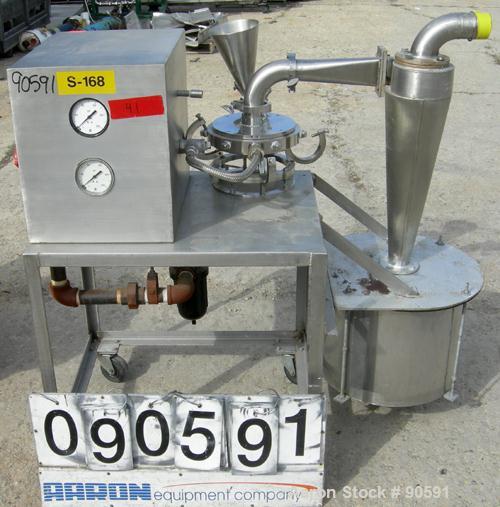 Used Sturtevant Micronizer Jet Mill, 316 Stainless Steel. Approximately 8" diameter x 1" deep chamber. Includes a cyclone with collection jar. Mounted on a stainless steel frame with casters.