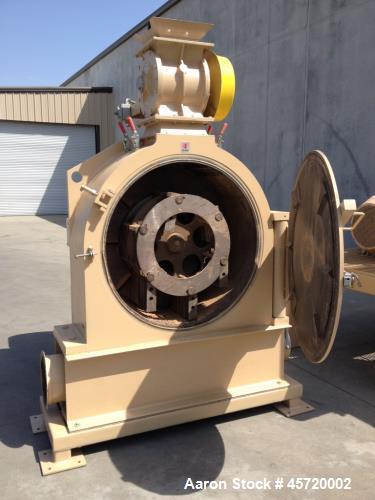Used Prater Model MM-18 Mega Mill. Unit has 150HP motor and has carbon steel contact. Hammer type: tool temp. Screen size: round hole triangular. Includes feed inlet, inlet, door and rear linere, air...