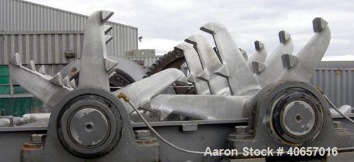 Used Lump Breaker, dual shaft, 304 stainless steel. (1) 4" diameter shaft with (7) 3 blade hook style knives, (1) 4" diameter shaft with (6) 3 blade hook style knives. (2) sets of stationary bars. 40...