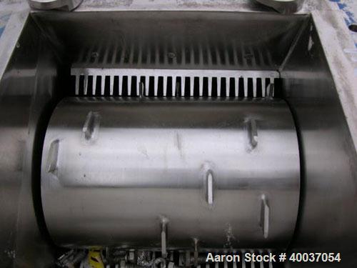 Used Franklin Miller Delumper, Model 1077S4DC, stainless steel. Sanitary design. Approximately 8" diameter x 12" wide rotor with teeth, side sizing combs. 12" x 12" feed opening. Requires motor.

