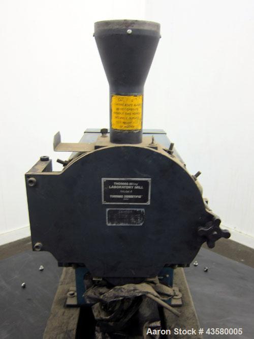 Used Thomas Wiley Cutting Mill, Model 4, Carbon Steel. 141 Cubic inch chamber 7-3/4” diameter x 3” deep. (4) Bolt on blade rotor, 6 stationary bed knives. Top feed with hopper, bottom discharge, hing...
