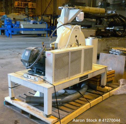 Used Bauermeister Universal Mill, Model UT22, Carbon Steel. Approximately 18-1/2" diameter x  6" deep sieve ring assembly, Approximately 17-1/2" diameter revolving rotor. Hinged front door with a top...