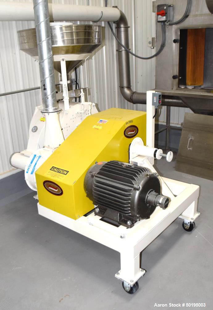 Used Meadows Mills Stone Burr Mill, Model 20N, Carbon Steel. Includes a feed hopper. Driven by a 10hp motor. Set up with blower discharge. Mounted on a frame with casters. Serial# 34521-13.  ADD 18% ...