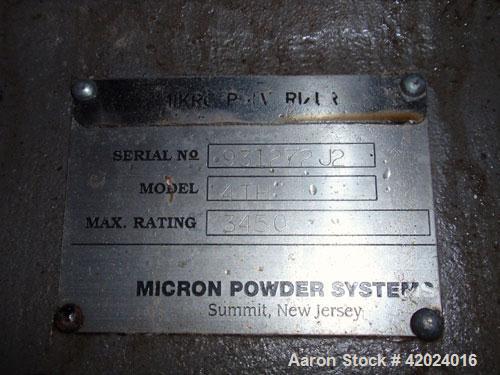 Used Micron Powder System Pulverizer, Model 4TH, stainless steel. Triple horizontal screw feeder with hopper. Pulverizer driven by a 75 hp motor. Mounted on a carbon steel frame.