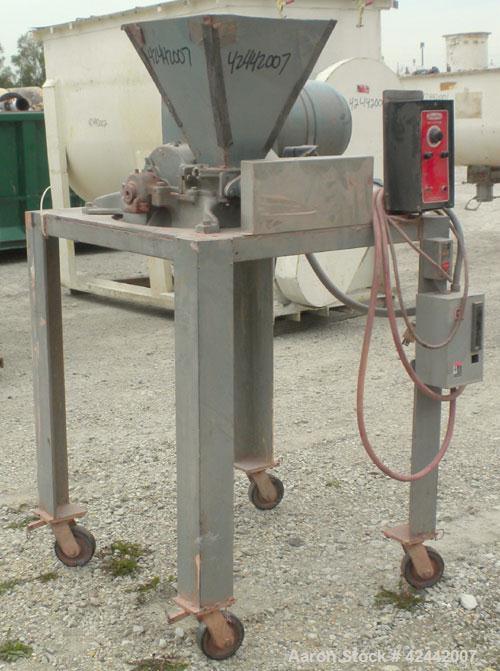 Used Mikro Pulverizer Hammer Mill, model 1SH, carbon steel. Approximate 8" diameter x 3-1/2" deep chamber with (6) 3’’ wide swinging stirrup hammers. Single screw feed, driven by a 1/4 hp, 90 volt, 1...