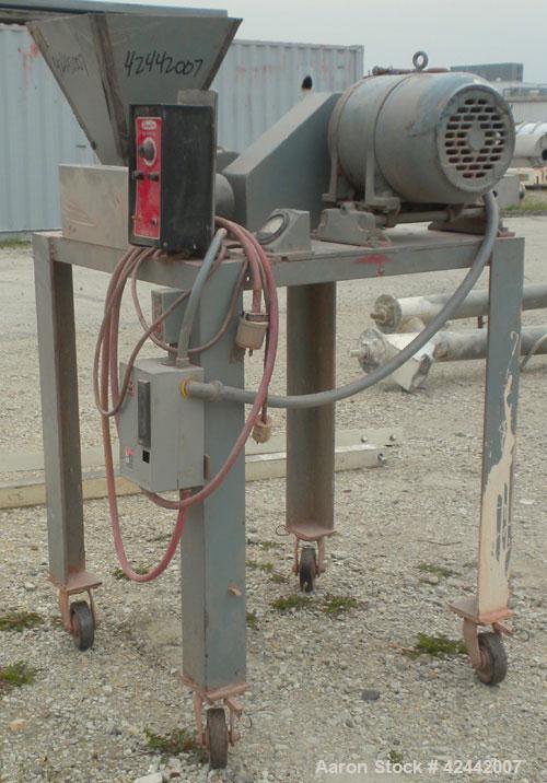 Used Mikro Pulverizer Hammer Mill, model 1SH, carbon steel. Approximate 8" diameter x 3-1/2" deep chamber with (6) 3’’ wide swinging stirrup hammers. Single screw feed, driven by a 1/4 hp, 90 volt, 1...
