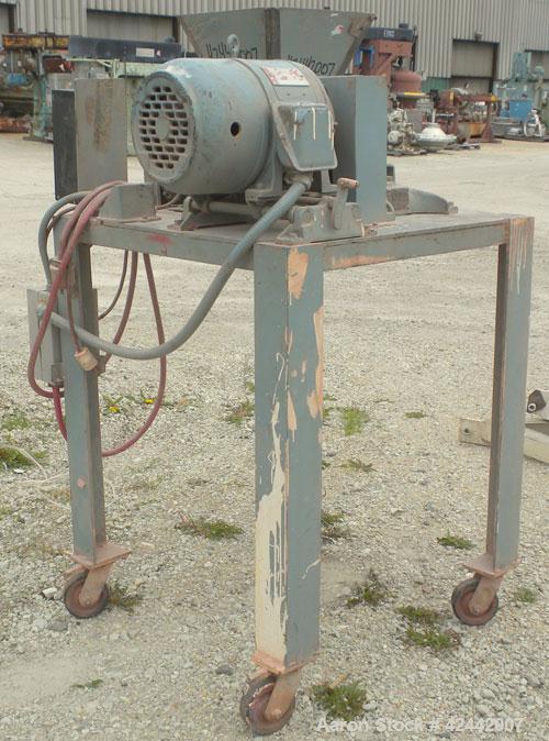 Used Mikro Pulverizer Hammer Mill, model 1SH, carbon steel. Approximate 8" diameter x 3-1/2" deep chamber with (6) 3’’ wide swinging stirrup hammers. Single screw feed, driven by a 1/4 hp, 90 volt, 1...