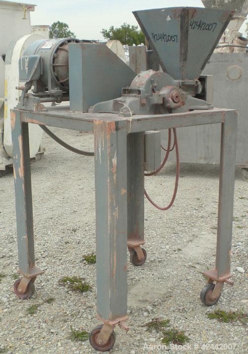 Used Mikro Pulverizer Hammer Mill, model 1SH, carbon steel. Approximate 8" diameter x 3-1/2" deep chamber with (6) 3’’ wide swinging stirrup hammers. Single screw feed, driven by a 1/4 hp, 90 volt, 1...