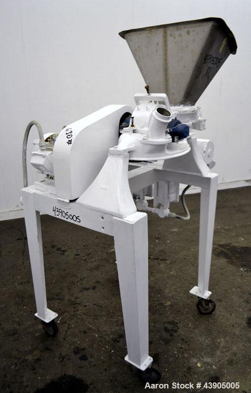 Used Mikro Pulverizer Hammer Mill, Model 1SH, 304 Stainless Steel. Approximately 8" diameter x 3-1/2" deep chamber with (6) 3” wide swinging stirrup hammers. Single screw feed, driven by a 1/2 hp, 3/...