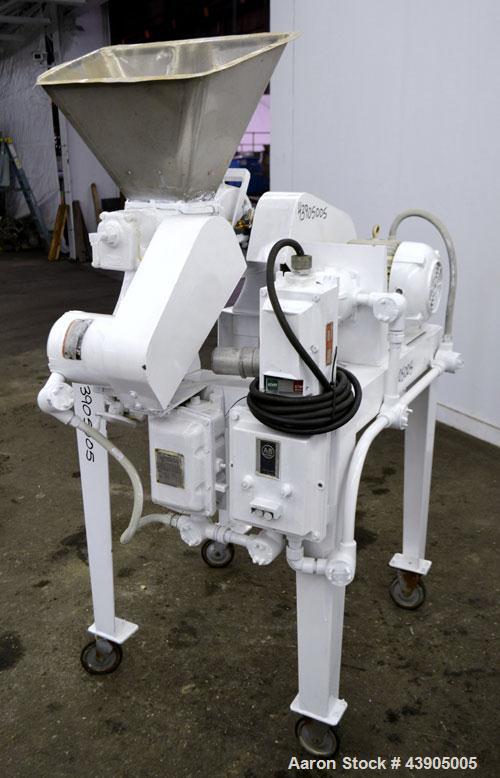Used Mikro Pulverizer Hammer Mill, Model 1SH, 304 Stainless Steel. Approximately 8" diameter x 3-1/2" deep chamber with (6) 3” wide swinging stirrup hammers. Single screw feed, driven by a 1/2 hp, 3/...