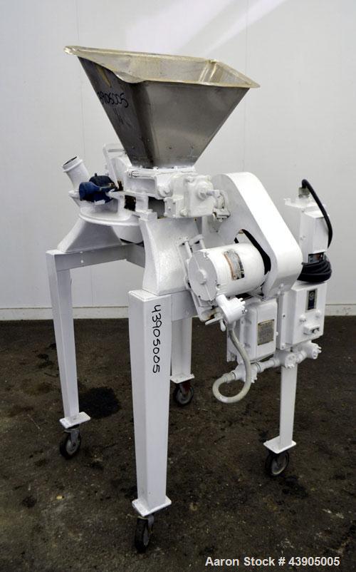 Used Mikro Pulverizer Hammer Mill, Model 1SH, 304 Stainless Steel. Approximately 8" diameter x 3-1/2" deep chamber with (6) 3” wide swinging stirrup hammers. Single screw feed, driven by a 1/2 hp, 3/...