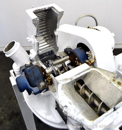Used Mikro Pulverizer Hammer Mill, Model 1SH, 304 Stainless Steel. Approximately 8" diameter x 3-1/2" deep chamber with (6) 3” wide swinging stirrup hammers. Single screw feed, driven by a 1/2 hp, 3/...