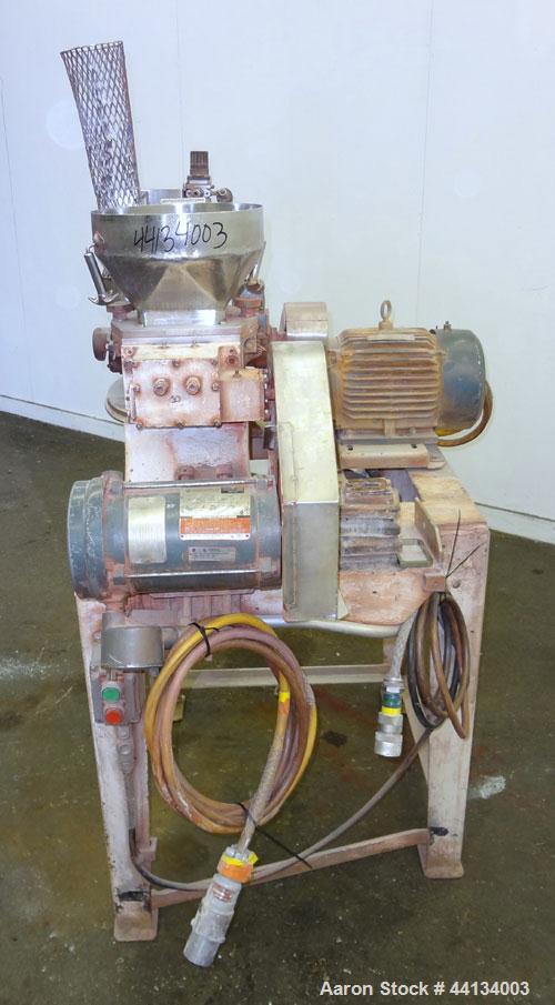 Used Mikro Pulverizer Hammer Mill, Model 1SH, 304 Stainless Steel. Approximately 8" diameter x 3-1/2" deep chamber with (6) 3” wide swinging stirrup hammers. Dual screw feed with hopper, driven by a ...