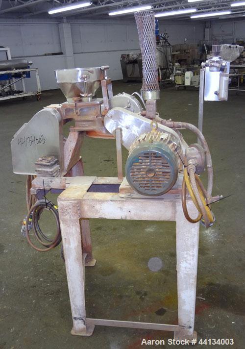 Used Mikro Pulverizer Hammer Mill, Model 1SH, 304 Stainless Steel. Approximately 8" diameter x 3-1/2" deep chamber with (6) 3” wide swinging stirrup hammers. Dual screw feed with hopper, driven by a ...