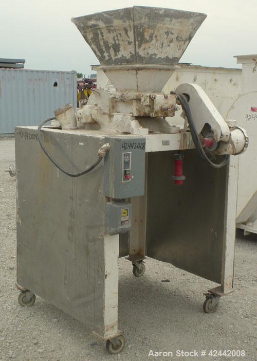Used Mikro Pulverizer Hammer Mill, model 2SI, carbon steel. Approximate 12" diameter x 6-1/2" deep chamber with (2) rows of (10) 2-1/2’’ wide swinging stirrup hammers. Dual screw feed, driven by a 1/...