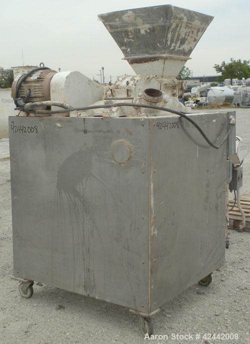 Used Mikro Pulverizer Hammer Mill, model 2SI, carbon steel. Approximate 12" diameter x 6-1/2" deep chamber with (2) rows of (10) 2-1/2’’ wide swinging stirrup hammers. Dual screw feed, driven by a 1/...