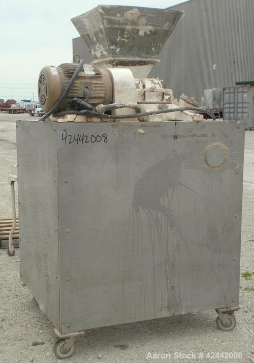 Used Mikro Pulverizer Hammer Mill, model 2SI, carbon steel. Approximate 12" diameter x 6-1/2" deep chamber with (2) rows of (10) 2-1/2’’ wide swinging stirrup hammers. Dual screw feed, driven by a 1/...