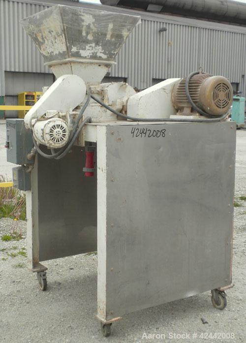 Used Mikro Pulverizer Hammer Mill, model 2SI, carbon steel. Approximate 12" diameter x 6-1/2" deep chamber with (2) rows of (10) 2-1/2’’ wide swinging stirrup hammers. Dual screw feed, driven by a 1/...