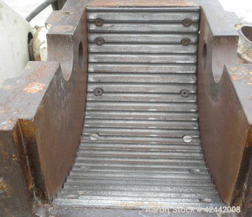 Used Mikro Pulverizer Hammer Mill, model 2SI, carbon steel. Approximate 12" diameter x 6-1/2" deep chamber with (2) rows of (10) 2-1/2’’ wide swinging stirrup hammers. Dual screw feed, driven by a 1/...