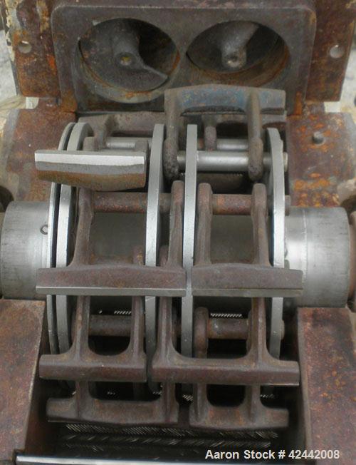 Used Mikro Pulverizer Hammer Mill, model 2SI, carbon steel. Approximate 12" diameter x 6-1/2" deep chamber with (2) rows of (10) 2-1/2’’ wide swinging stirrup hammers. Dual screw feed, driven by a 1/...