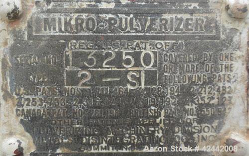 Used Mikro Pulverizer Hammer Mill, model 2SI, carbon steel. Approximate 12" diameter x 6-1/2" deep chamber with (2) rows of (10) 2-1/2’’ wide swinging stirrup hammers. Dual screw feed, driven by a 1/...