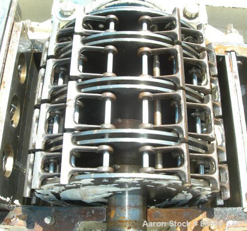 Used Mikro Pulverizer, Carbon Steel. Approximate 20" diameter x 12" wide rotor with 16 rows of 4 swinging stirrup hammers. 13" x 15" top feed with 304 stainless steel hopper, triple screw chamber fee...
