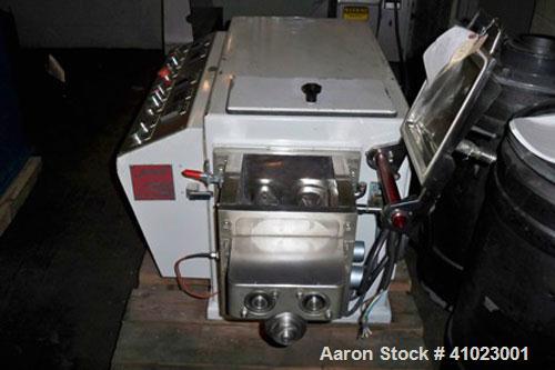 Used Jaygo Baker Perkins Model AME-7 Double Arm Sigma Mixer Extruder. Manufactured 1997. Unit features approximately 2 gallon working capacity, 7 1/2" long x 7" wide x 7" deep mix trough, stainless s...