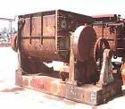 USED: Baker Perkins 500 gallon double arm mixer. Stainless steel interior, carbon steel duplex blades with serrated edges, geared at one end, carbon steel, jacketed bowl 64