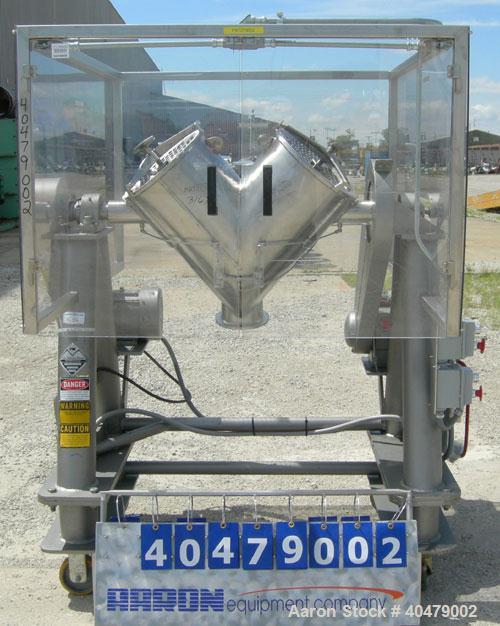 Used Patterson Kelley twin shell dry blender, 2 cubic foot capacity, 316 stainless steel. Max material density 85 pounds per cubic foot. 14" diameter cones with quick release covers. Shell driven by ...