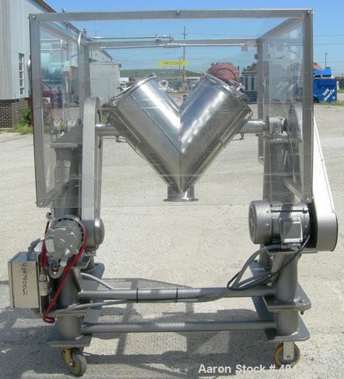 Used Patterson Kelley twin shell dry blender, 2 cubic foot capacity, 316 stainless steel. Max material density 85 pounds per cubic foot. 14" diameter cones with quick release covers. Shell driven by ...